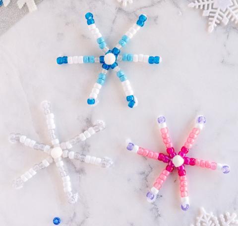 Snowflakes made out of colorful beads. 