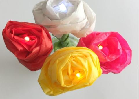 Roses made out of paper tissue, ribbons, and small LED light bulbs. 