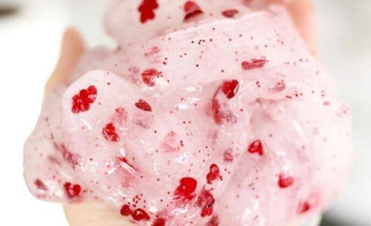 Slime made out of glue, water and liquid starch with heart confettii. 